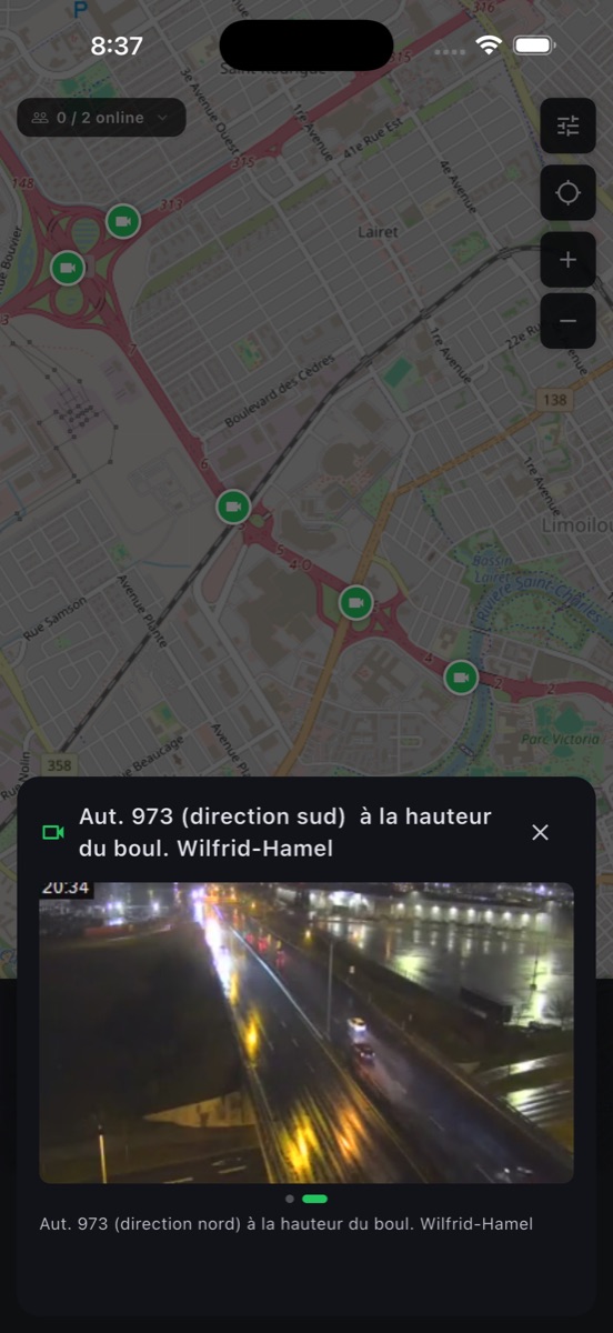 Map Telemetry traffic camera overlay — green camera icons along the highway with a live camera feed sheet showing the road below.